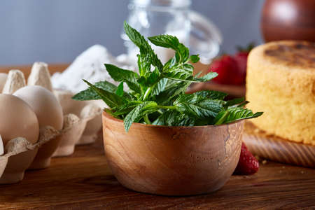 Delicious cake with fresh organic strawberries and mint, top view, close-up, selctive focus. Sweet...