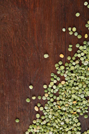 Green peas on rustic wooden background, close-up, top view, selective focus, vertical. Some copy space for your inscription. Studio shot. Macro. Nutritious organic protein. Healthy food concept. Healthy eating, dieting.の写真素材