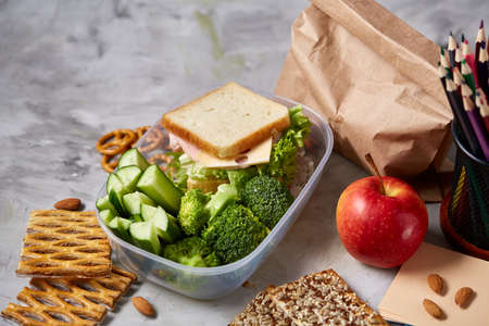 Back to School concept, school supplies, assortment of biscuits, paper paper with food and...