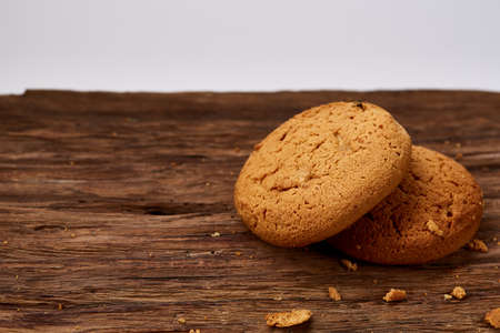 Pile of oat cookies on wooden table, close-up, selective focus. Crunchy stack. Delicious snack....