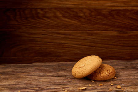 Pile of oat cookies on wooden table, close-up, selective focus. Crunchy stack. Delicious snack....