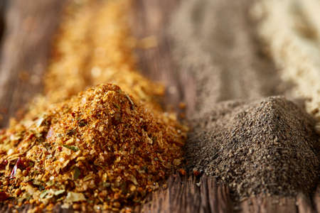 Colorful spice background with different color spices, macro, selective focus, shallow depth of field. Various spices arranged in vertical rows. Abstract textured background. Colorful pattern.の写真素材