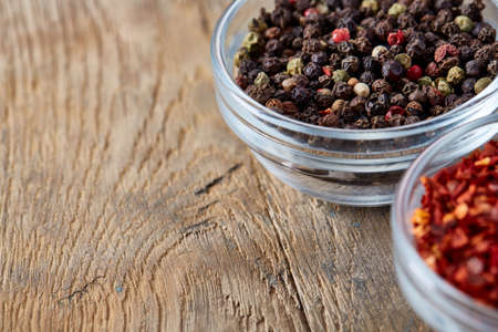 Bowls with different types of spicy on wooden table, top view, close-up, selective focus....