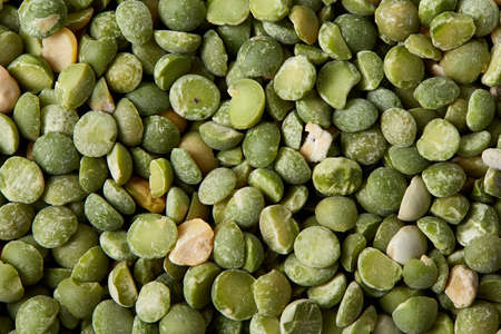 Green peas on rustic wooden background, close-up, top view, selective focus. Some copy space for...