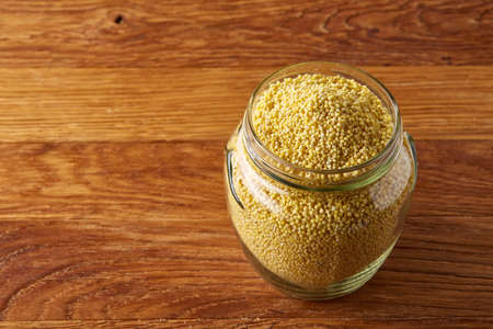 Lentils in a wooden bowl on rustic wooden background, top view, close-up, selective focus. Some copy...