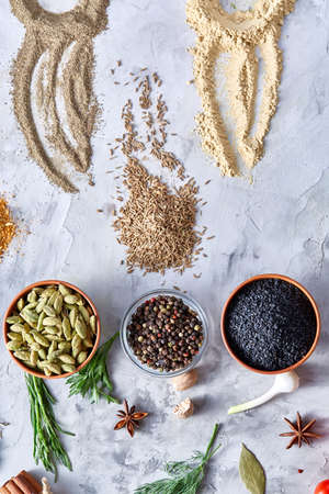 Different bowls with spices arranged in rows on white textured background, top view, selective...