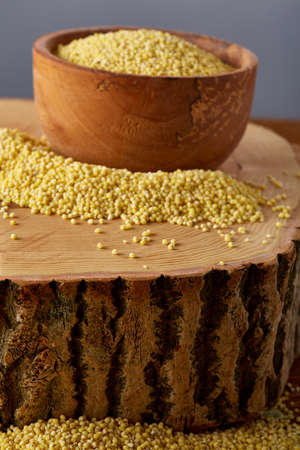 Lentils in a wooden bowl on rustic wooden background, top view, close-up, selective focus.