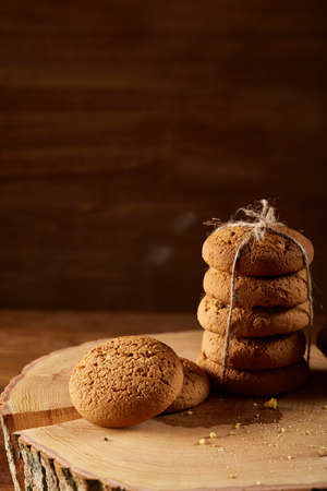 Traditional Christmas tea concept with a large set of cookies on a homespun napkin, cinnamon sticks...