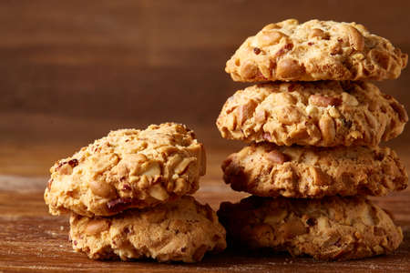 Bunch of chocolate biscuits on a rustic wooden background, close-up, selective focus. Bright gourmet...