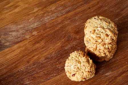 Bunch of chocolate biscuits on a rustic wooden background, close-up, selective focus. Bright gourmet...