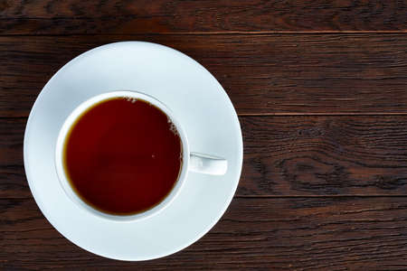 Looking Down on a cup of tea hot beverage with cinnamom, mint leaves and fruits of star anise.の写真素材