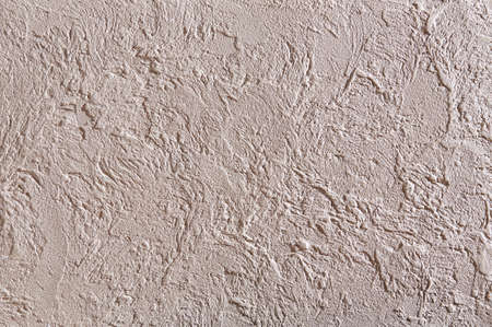 Close-up surface detail of old rough white plaster wall texture, macro. Empty light scratches effect background for architecture material and interior decoration concepts, vintage and modern style. Some open space for text or inscription.の写真素材