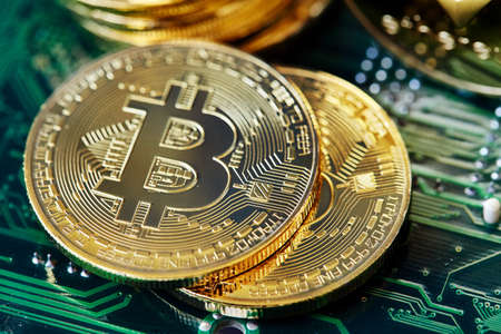 Conceptual image of different cryptocurrency with bitcoins on dark table, close-up, selective focus, front focus, shallow depth of field. Cryptocurrency concept. Physical bit coin. Digital currency. Cryptocurrency. Golden coin with bitcoin symbol.の写真素材