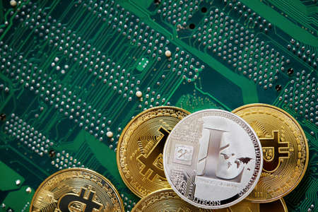 Stack of cryptocurrencies arranged on the motherboard. Bitcoin as most important cryptocurrency concept, close-up, selective focus. Cryptocurrency mining. Virtual business. Electornic commerce. Banking monetary. Cryptocurrency diversification.の写真素材