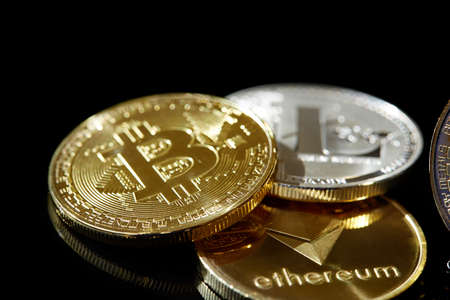 Conceptual image of different cryptocurrency with bitcoins on dark table, close-up, selective focus,...