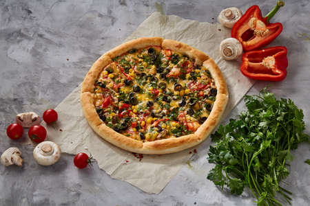Tasty Italian pizza and its ingredients on white textured background, top view, close-up, selective focus. Delicious snack. Traditional homemade Italian pizza. Mediterranian cuisine. Fast food concept.の写真素材