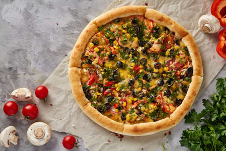 Tasty Italian pizza and its ingredients on white textured background, top view, close-up, selective focus. Delicious snack. Traditional homemade Italian pizza. Mediterranian cuisine. Fast food concept.の写真素材