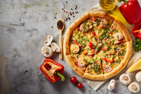 Tasty Italian pizza and its ingredients on white textured background, top view, close-up, selective focus. Delicious snack. Traditional homemade Italian pizza. Mediterranian cuisine. Fast food concept.の写真素材