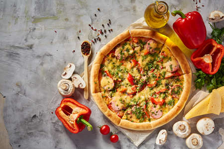 Tasty Italian pizza and its ingredients on white textured background, top view, close-up, selective focus. Delicious snack. Traditional homemade Italian pizza. Mediterranian cuisine. Fast food concept.の写真素材