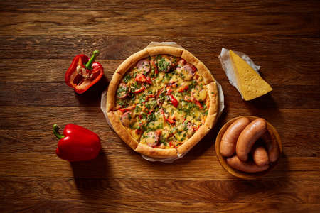 Freshly baked delicious pizza on rustic wooden background, top view, close-up, selective focus. Some copy space for your text. Delicious snack. Yummy junk food. Traditional Italian pizza. Mediterranian cuisine. Fast food concept.の写真素材