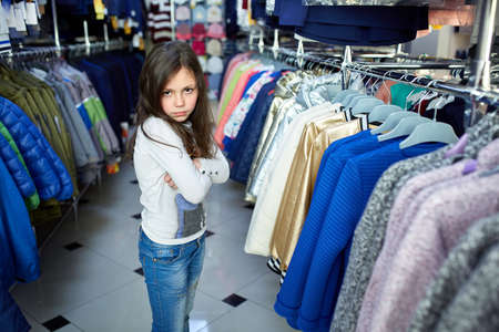 cute little girl on shopping. portrait of a kid with shopping bags. child in dress, sunglasses and shoes near shopping mall having fun.の写真素材