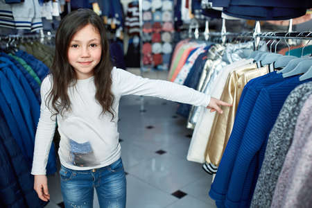 cute little girl on shopping. portrait of a kid with shopping bags. child in dress, sunglasses and shoes near shopping mall having fun.の写真素材