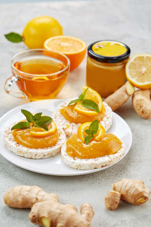 Full breakfast with a varied and healthy diet - Bowl of cereal breads with fresh seasonal fruit raspberries, an orange squeezed honey teaの写真素材