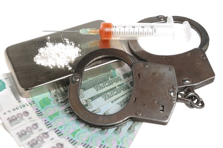 Drugs, syringe with blood, handcuffs and money on white backgroundの写真素材