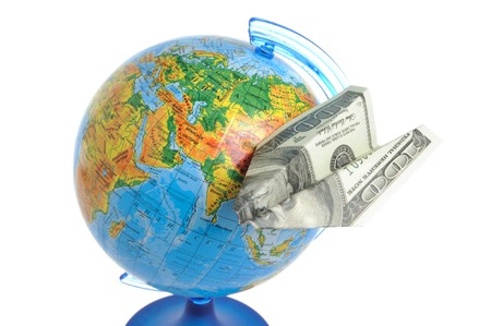 Globe with origami plane made from dollar isolated on white backgroundの写真素材