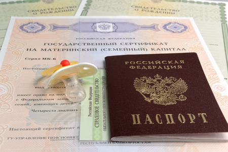 Russian passport with baby dummy and maternal, birth and pension certificatesの写真素材