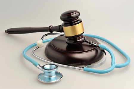Stethoscope with judge gavel on gray backgroundの写真素材