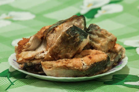  Fried fish sliced on a plateの写真素材