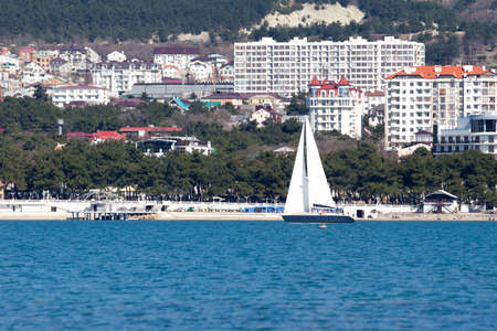 Sailboat on sea with views of the cityの写真素材