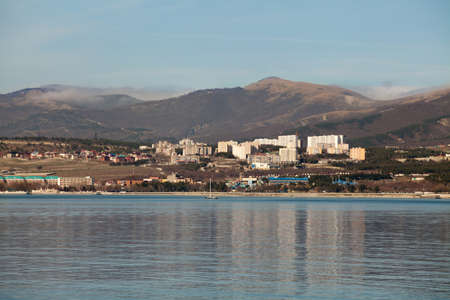 View from the sea to the shore, mountains, houses, sea surfaceの写真素材