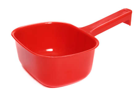 Plastic ladle of red on a white backgroundの写真素材
