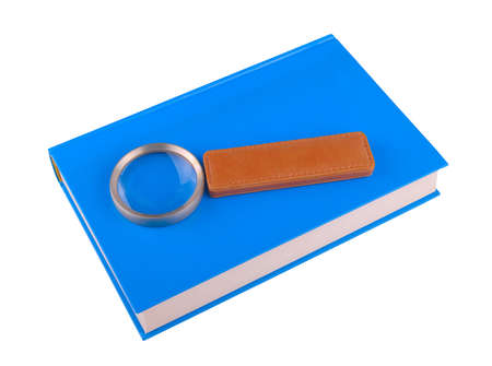 Magnifying glass lying on the bookの写真素材