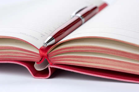 Open diary and pen red, closeup, shallow DOFの写真素材