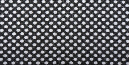 Dark knitted fabric with white polka dots, background