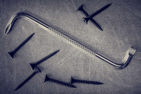 Double-sided screwdriver and screws, macro, vintage