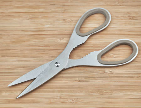 Kitchen scissors on a wooden board