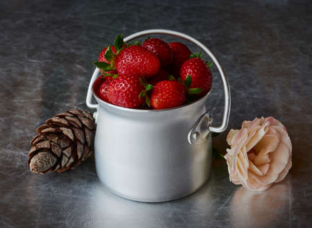 View on fresh strawberry in aluminum can on a silvery backgroundの写真素材