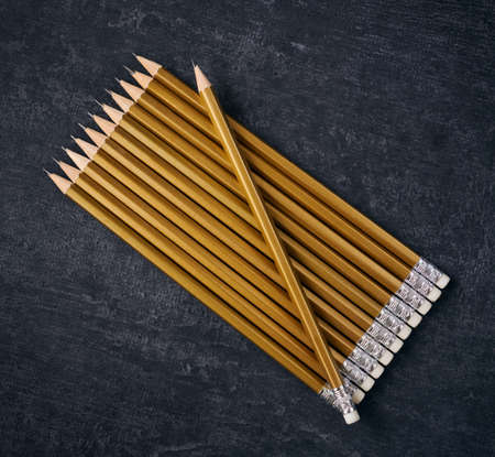 Simple pencils golden color on gray background