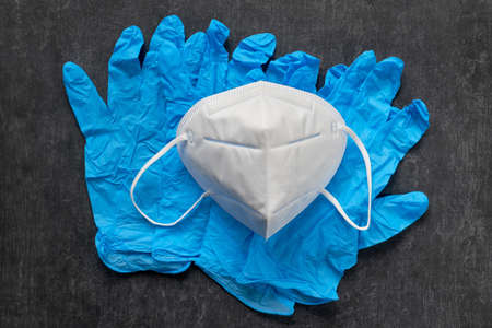 White protection mask for face and disposable nitrile gloves, protection against coronaviruses and infectionsの写真素材