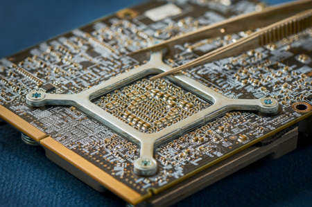 Electronic circuit board on blue background close up