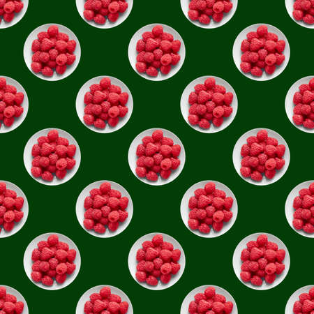 Red raspberry on a green background. Top view, raspberry patternの写真素材