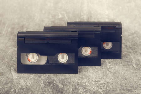 Three HI 8 sompact video cassettes on gray surface, retro, closeupの写真素材