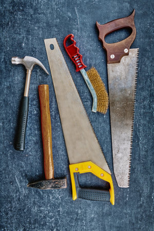 Vintage carpentry tools on an grungy gray background, handwork concept, flat lay