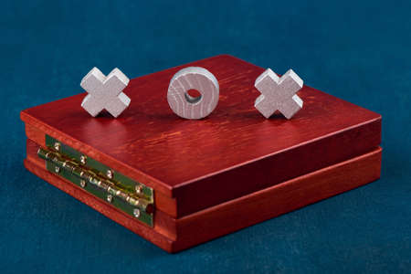 Game Tic Tac Toe, game tokens on a wooden box