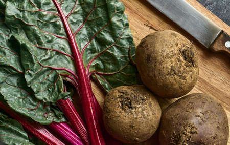 Beets and haulm on a cutting board in close-up