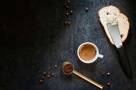 Cup of coffee, wheat bread, butter and coffee beans. Top view with copy space for textの写真素材